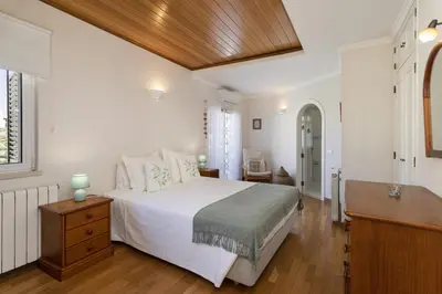a bedroom with a white bed and a wooden ceiling at Vila Caraibas - Vilamoura - by HDproperties in Vilamoura