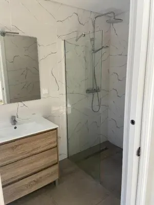 a bathroom with a shower with a sink and a mirror at Quinta Verde Algarve in Medronhal