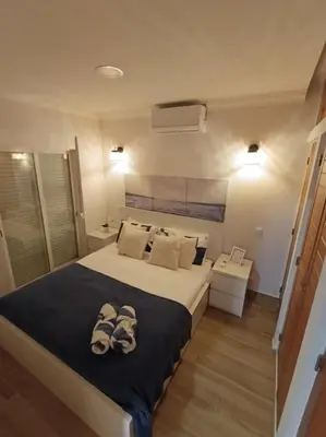a bedroom with a large bed with shoes on it at Albufeira - Sun, Pool and Marina View! in Albufeira