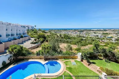 an apartment with a swimming pool in a resort at Albufeira - Sun, Pool and Marina View! in Albufeira