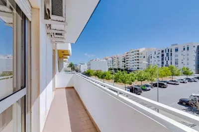 a balcony with a view of a parking lot at Spacious 2 bedroom apartment in Faro in Faro