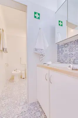 a white bathroom with a sink and a toilet at Spacious 2 bedroom apartment in Faro in Faro
