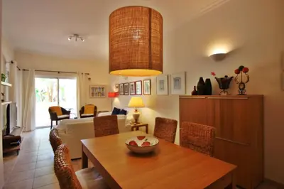 a living room with a table and a couch at Los Arcos 3 - Pool & Vilamoura Center in Vilamoura