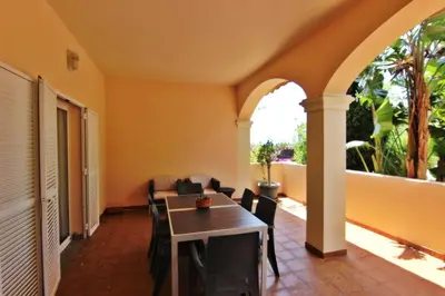 a room with a table and chairs on a balcony at Los Arcos 3 - Pool & Vilamoura Center in Vilamoura