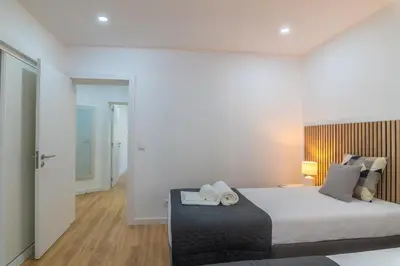 a bedroom with a bed with two towels on it at Beachside Bliss T2 with Pool & Beach Access by Drago Rentals in Albufeira