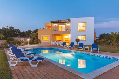 a villa with a swimming pool in front of a house at Villa Maya Bay by Algarve Vacation in Guia