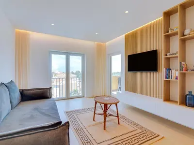 a living room with a couch and a tv at AL - Apartamento Novo Horizonte in Vilamoura