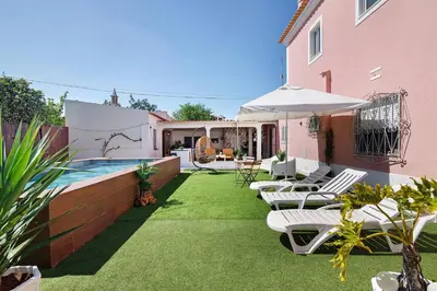 a patio with a table and chairs on a balcony at J R Dream house in Quarteira