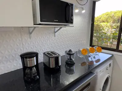 a kitchen counter with two glasses of oranges on it at Balaia Golf Village apt 105 in Albufeira