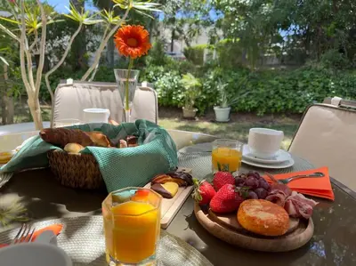 a table with a tray of food and orange juice at Balaia Golf Village apt 105 in Albufeira
