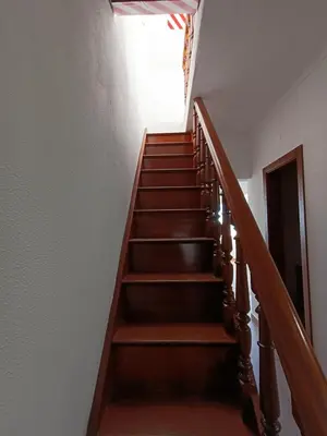 a stairway with wooden steps and a window at Apartamento Praia da Gale in Albufeira