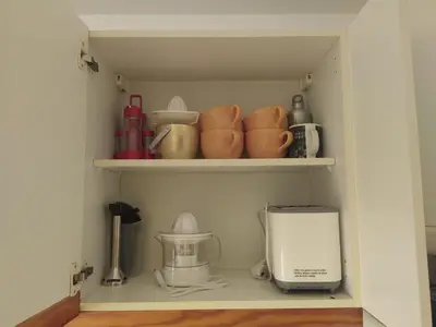 a shelf with a toaster and cups and a blender at SolNascenteII-Vilamoura in Quarteira