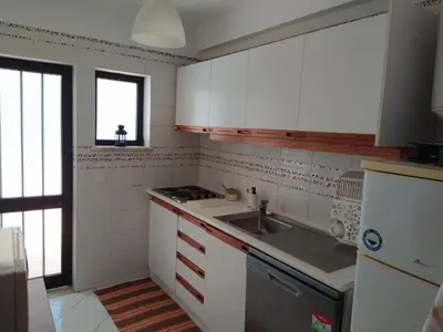 a kitchen with white cabinets and a sink at SolNascenteII-Vilamoura in Quarteira