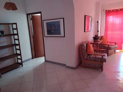 a living room with a staircase and a couch and chair at SolNascenteII-Vilamoura in Quarteira