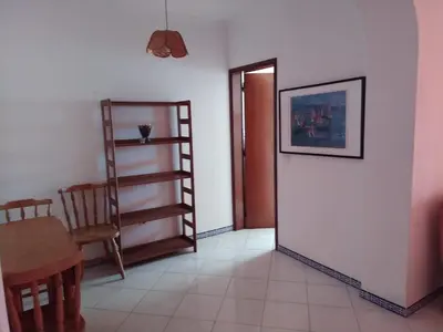 a room with a table and a chair and a door at SolNascenteII-Vilamoura in Quarteira
