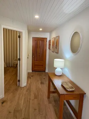 a room with a table with a lamp and a door at Torga Apartment in Albufeira