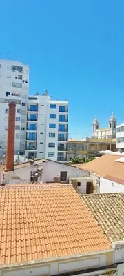 a view of a roof with buildings in the background at Apartment Center View in Faro