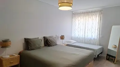 a small bedroom with a bed and a window at Apartment Center View in Faro