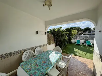 a table with food and an umbrella on a patio at Faro Terrace Villa by Homing in Faro