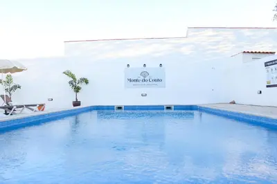 a swimming pool in a building with a sign that reads water culture at Monte do Couto in Albufeira