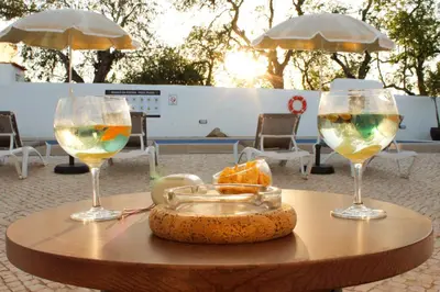two wine glasses and a tray of food on a table at Monte do Couto in Albufeira