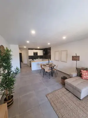 a living room with a couch and a table at Sea Turtle Apartment - Albufeira in Albufeira