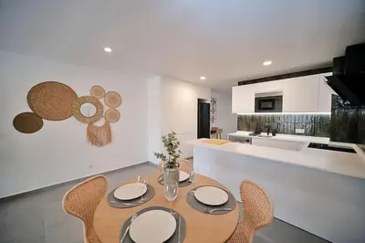 a dining room with a table and chairs in a kitchen at Sea Turtle Apartment - Albufeira in Albufeira