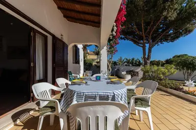 a dining table and chairs on a patio at NEW! 4bedroom Villa - Private Pool and Sea view in Guia