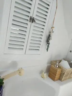 a kitchen sink with a window with blinds over it at Houseboat - Faro in Ria Formosa in Faro