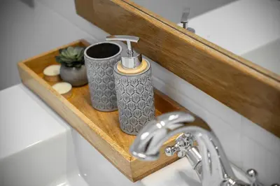 a bathroom sink with a soap dispenser on a wooden shelf at Casa do Avô - Faro City in Faro
