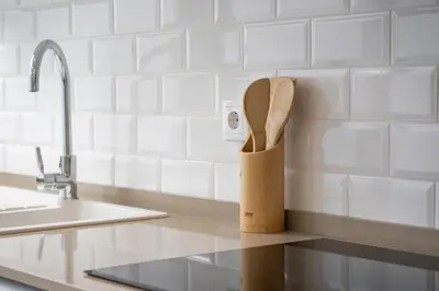 a knife block with wooden utensils on a kitchen counter at Casa do Avô - Faro City in Faro