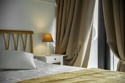 a bedroom with a bed and a table with a lamp at Casa do Avô - Faro City in Faro