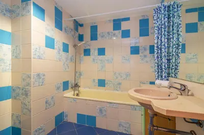 a blue and white bathroom with a sink and a tub at Marina de Albufeira by Garvetur in Albufeira