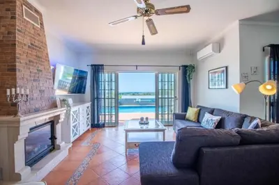 a living room with a couch and a fireplace at Charmante Villa mit 3 Schlafzimmer und Blick zum Meer in Santa Bárbara de Nexe