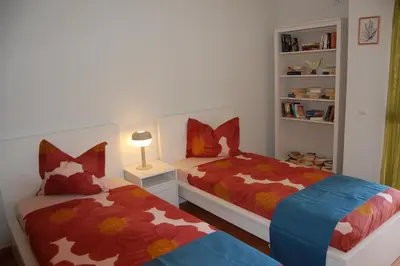 a bedroom with two beds and a book shelf at Charmante Villa mit 3 Schlafzimmer und Blick zum Meer in Santa Bárbara de Nexe