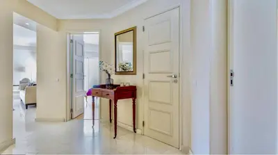 a hallway with a door and a table with a mirror at Sandnblue - Encosta Do Lago Resort Club - Quinta do lago near Beach & lake BEST LOCATION in Quinta do Lago