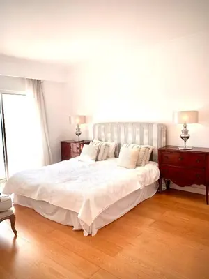a bedroom with a large white bed and two night stands at Sandnblue - Encosta Do Lago Resort Club - Quinta do lago near Beach & lake BEST LOCATION in Quinta do Lago