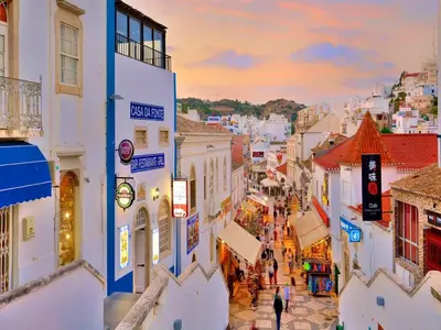 a view of a city street at sunset at Luxury 1 Bedroom Apartment, Marina de Albufeira in Albufeira