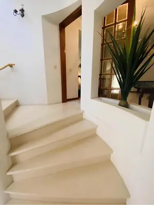a staircase in a house with a potted plant at Moradia VSSG em Vilamoura in Quarteira