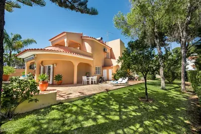 a swimming pool with a patio and a house at 4 Bedrooms Private Pool Close To All Amenities in Quarteira