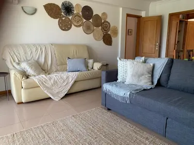 a living room with a couch and a chair at Galé Garden House in Guia