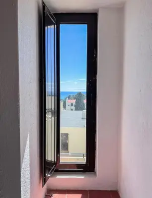 a window in a building with a view of the ocean at Sea View One Bedroom with Swimming Pool Ponce 282 in Albufeira