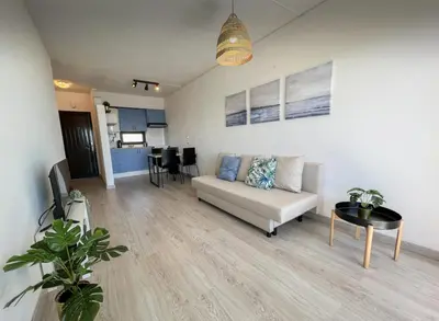 a living room with a couch and a table at Sea View One Bedroom with Swimming Pool Ponce 282 in Albufeira