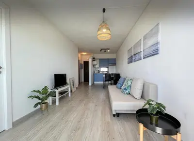 a living room with a couch and a tv at Sea View One Bedroom with Swimming Pool Ponce 282 in Albufeira