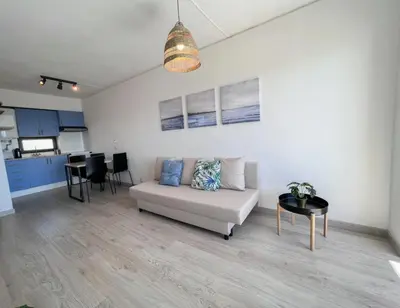 a living room with a couch and a table at Sea View One Bedroom with Swimming Pool Ponce 282 in Albufeira