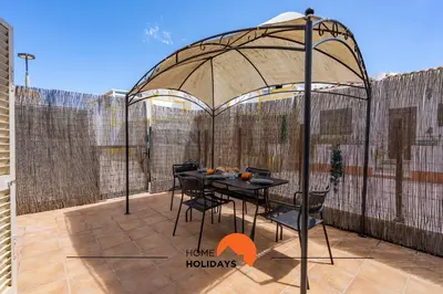 a gazebo with a table and chairs on a patio at #229 Quinta das Areias by Home Holidays in Albufeira