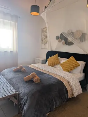a bedroom with two beds with towels on it at Casa de Aloe in Albufeira