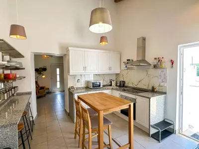 a kitchen with a wooden table in a room at Casa de Aloe in Albufeira