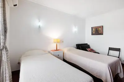 a room with two beds and a lamp on a table at Oura Southvilla Algarve in Albufeira