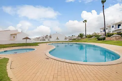 a living room with a blue couch and a table at Oura Southvilla Algarve in Albufeira